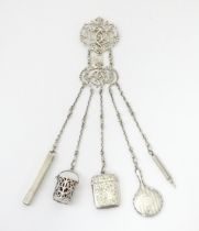 A silver chatelaine with openwork scrolling detail and having five chains, hallmarked Chester