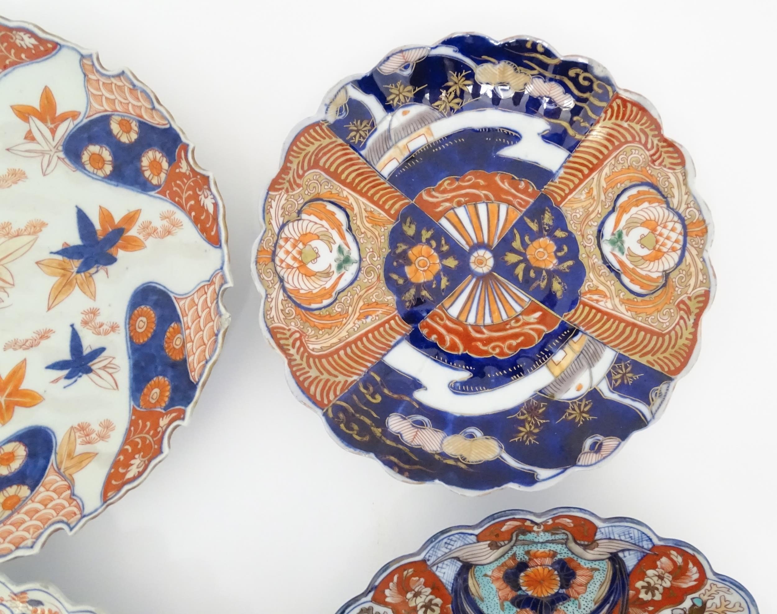 Four Japanese chargers with shaped edges decorated in the Imari palette with flowers, foliage and - Image 6 of 7