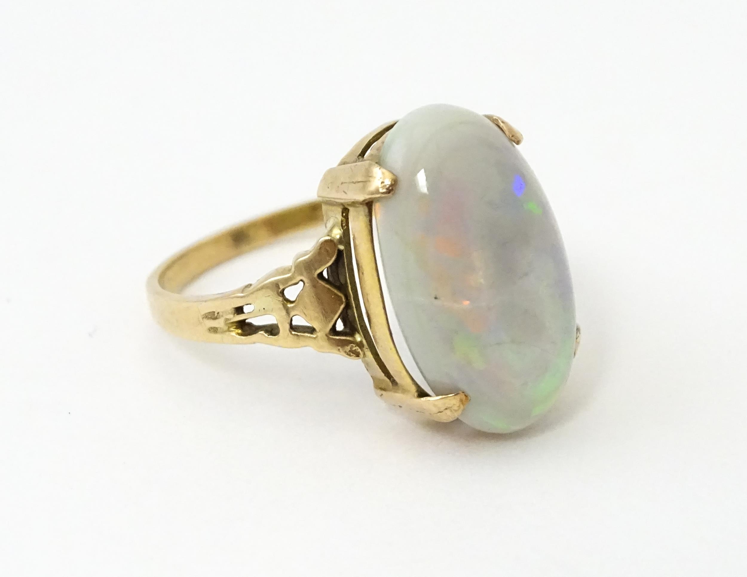 A 9ct gold ring set with large opal cabochon. The opal approx 3/4" long. Ring size approx. 0 - Image 6 of 10