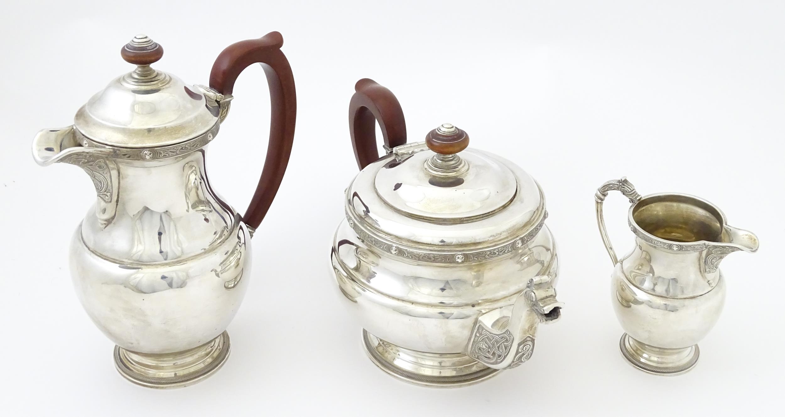 A three piece silver tea set comprising teapot, hot water pot and cream jug, with Celtic style - Image 2 of 20