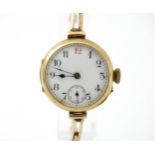 A 9ct gold cased ladies wristwatch with white enamel dial having Arabic numerals a subsidiary