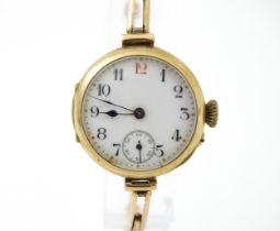 A 9ct gold cased ladies wristwatch with white enamel dial having Arabic numerals a subsidiary