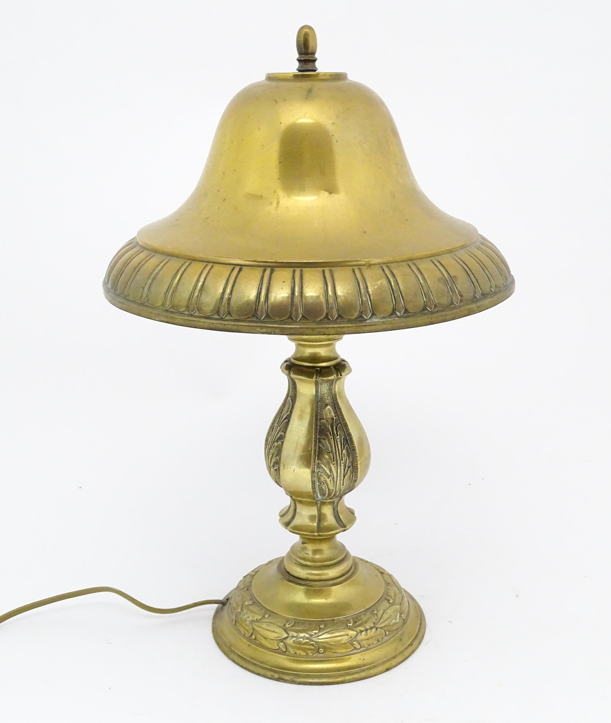 A 20thC brass table lamp with foliate detail and brass domed shade. Approx. 17" high Please Note -