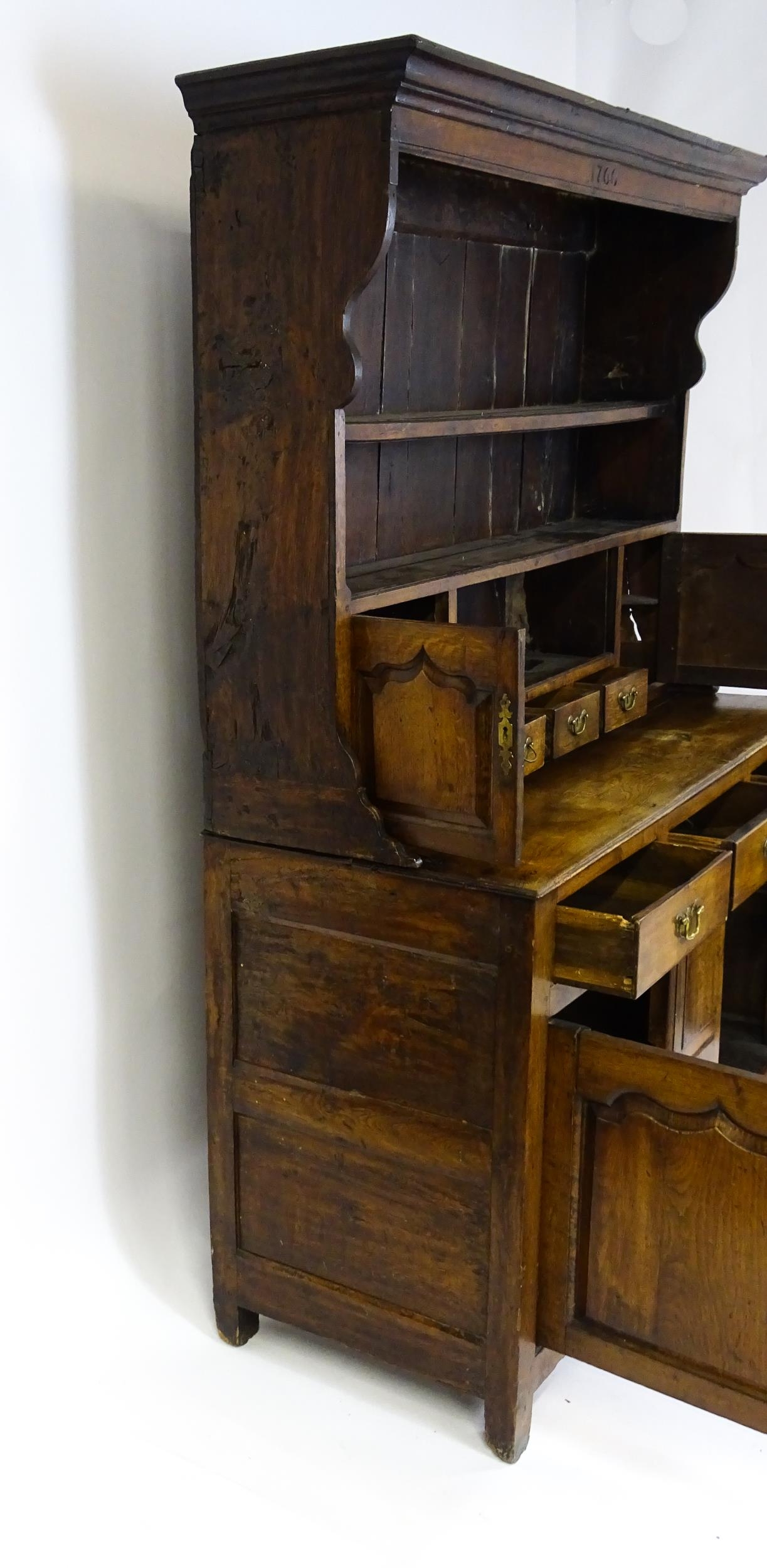 A mid 18thC oak dresser with a moulded cornice above three graduated shelves flanked by panelled - Image 9 of 9