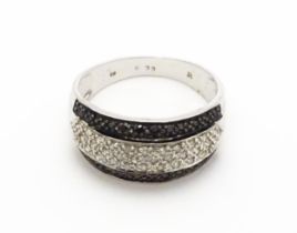 A 9ct white gold ring set with banded white and black diamonds. Approx. Q 1/2 Please Note - we do