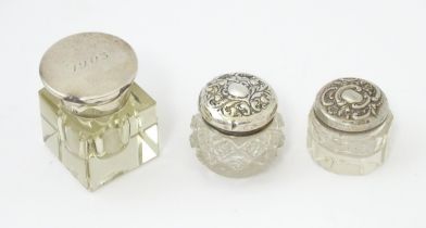 A glass inkwell of squared form with silver mounts and top hallmarked Birmingham 1925, maker