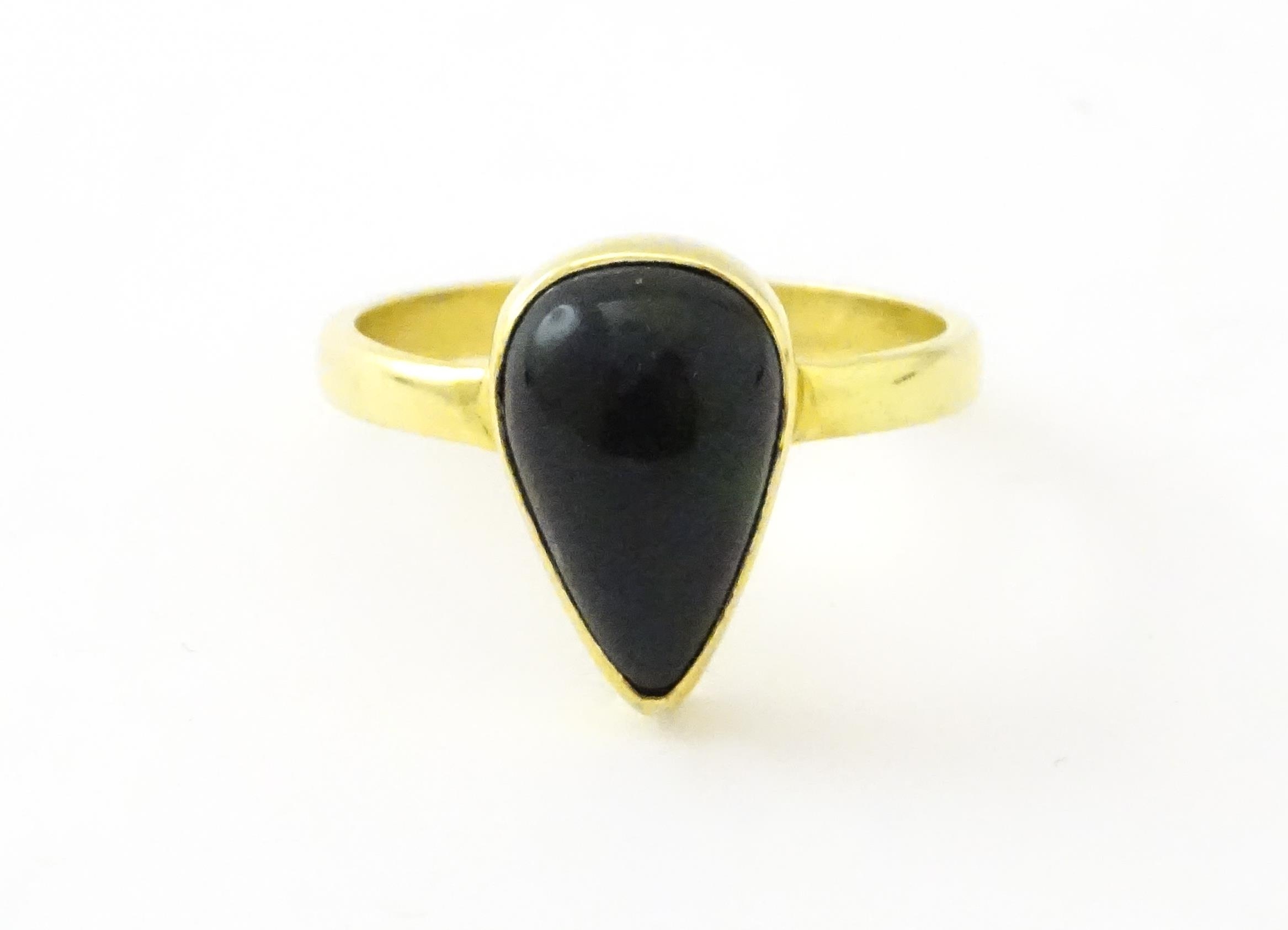 A silver gilt ring set with black opal style cabochon. Ring size approx. O. Please Note - we do - Image 4 of 6