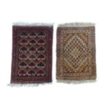 Carpets / Rugs: Two small rugs, one with burgundy ground with repeating motifs, the other with