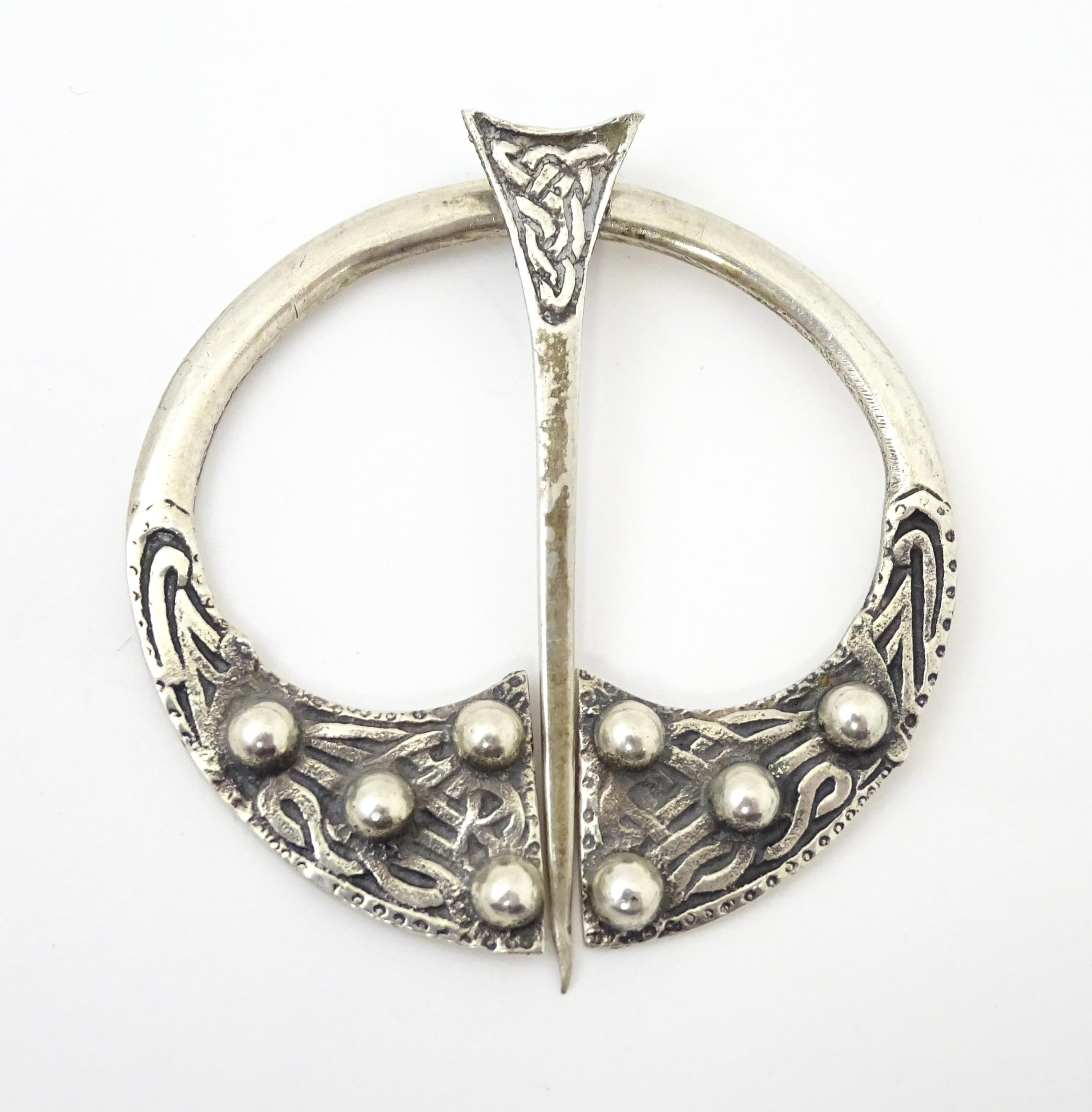 A Scottish silver penannular brooch / pin with Celtic decoration. Hallmarked Glasgow 1941 maker