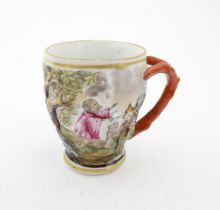 A Continental coffee cup decorated in relief with animals in a landscape. Marked under with