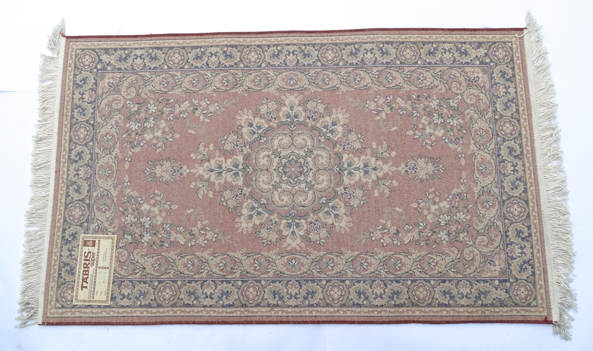 Carpet / Rug : A red ground rug with central floral motif, bordered by floral and foliate scroll - Image 2 of 7