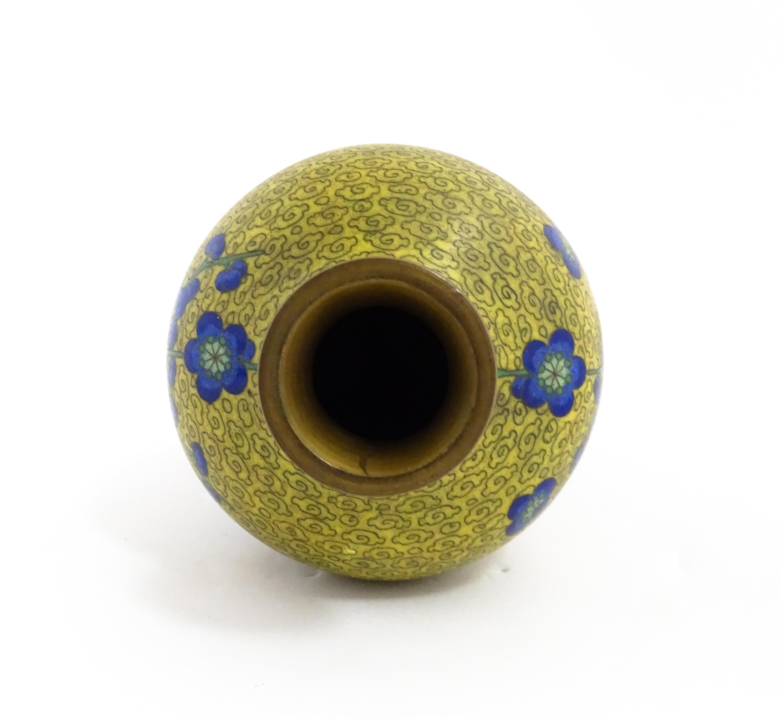 A Chinese cloisonne vase with a yellow ground decorated with blue prunus flowers / blossom. - Image 2 of 7