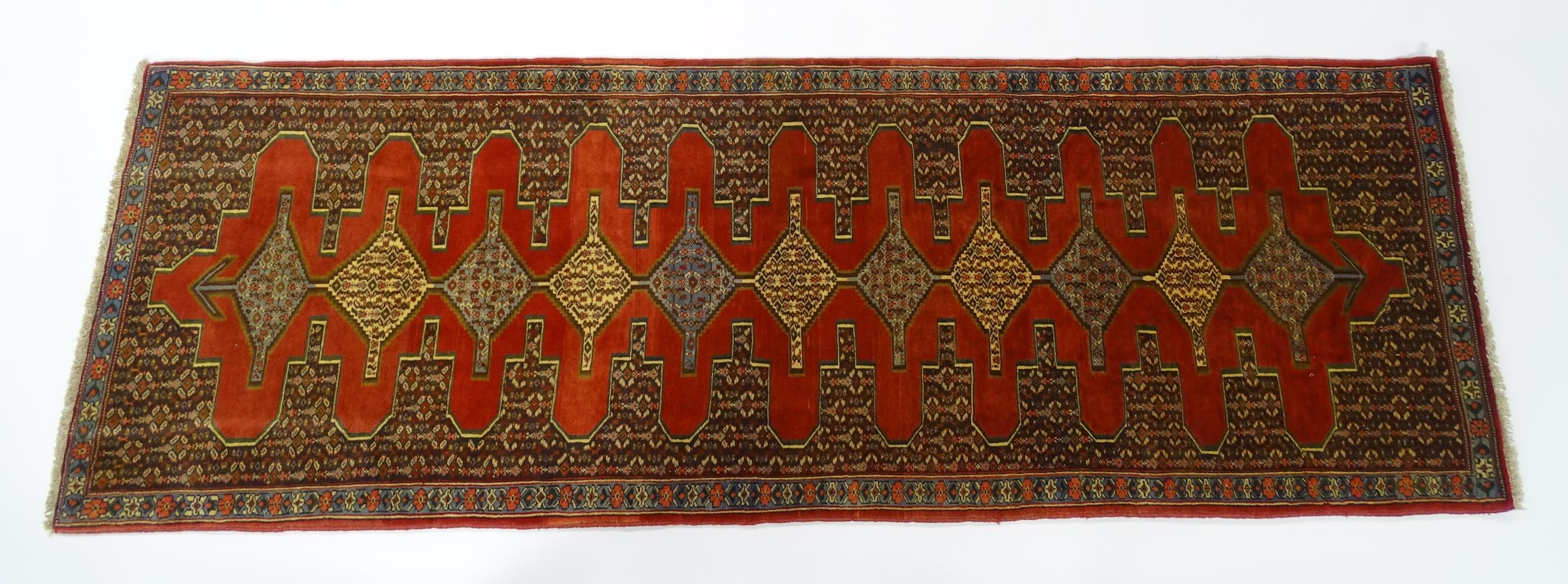 Carpet / Rug : A North West Persian Senneh runner with a red ground decorated with central repeating - Image 3 of 9