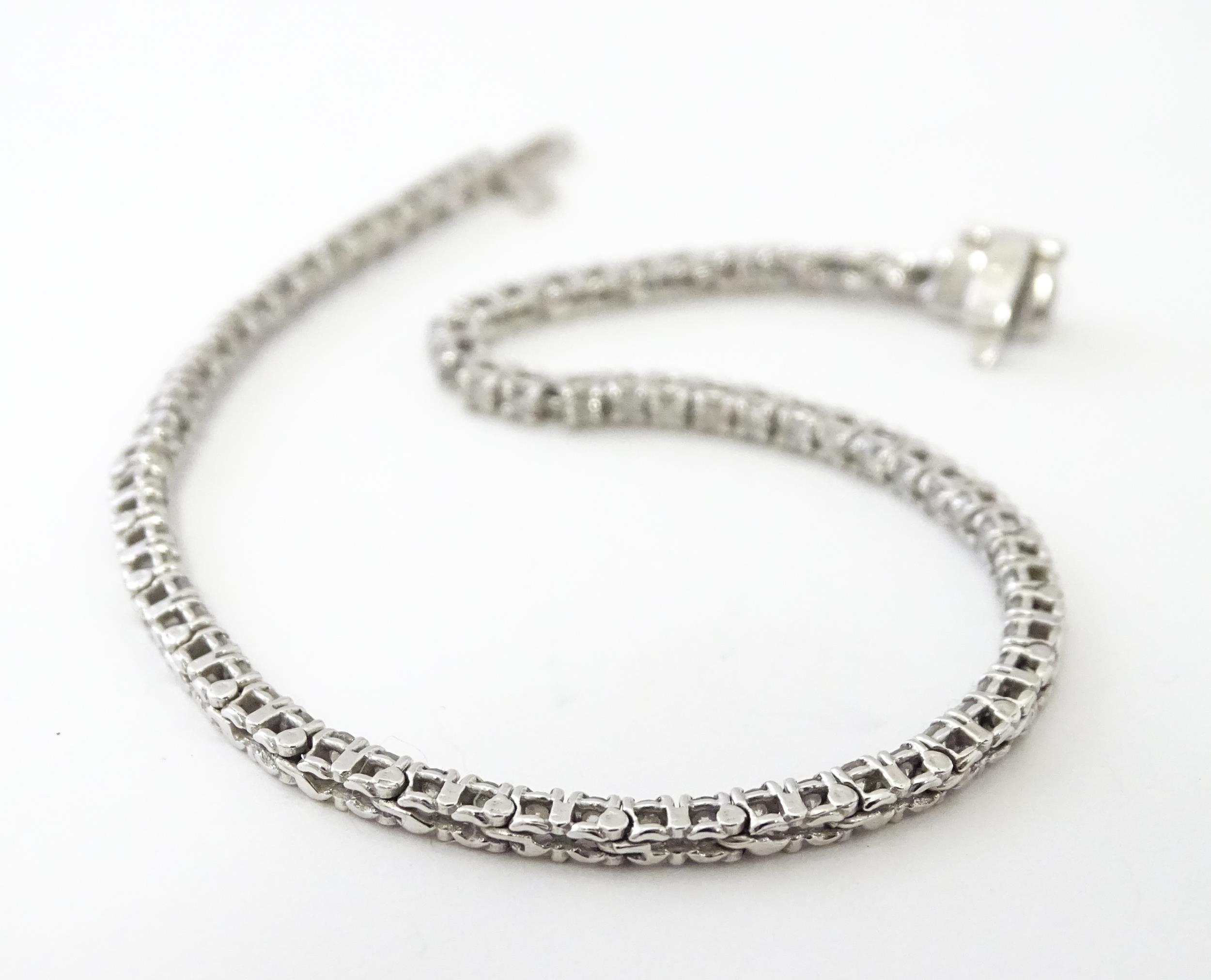 A 14ct white gold tennis bracelet set with diamonds. Approx 7 1/2" long Please Note - we do not make - Image 8 of 10