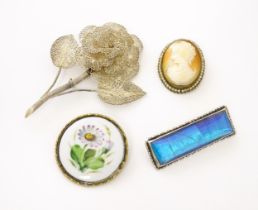 Four brooches comprising a Rosenthal brooch, a gilt metal brooch set with shell carved cameo