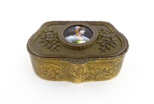 An early 20thC French gilt metal ring box of shaped form with floral and foliate decoration, the lid