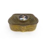 An early 20thC French gilt metal ring box of shaped form with floral and foliate decoration, the lid