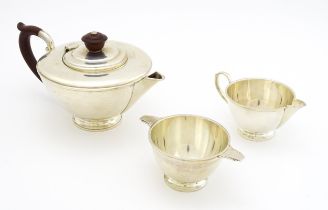 An Art Deco silver three piece tea set comprising teapot, sugar bowl and milk jug, hallmarked