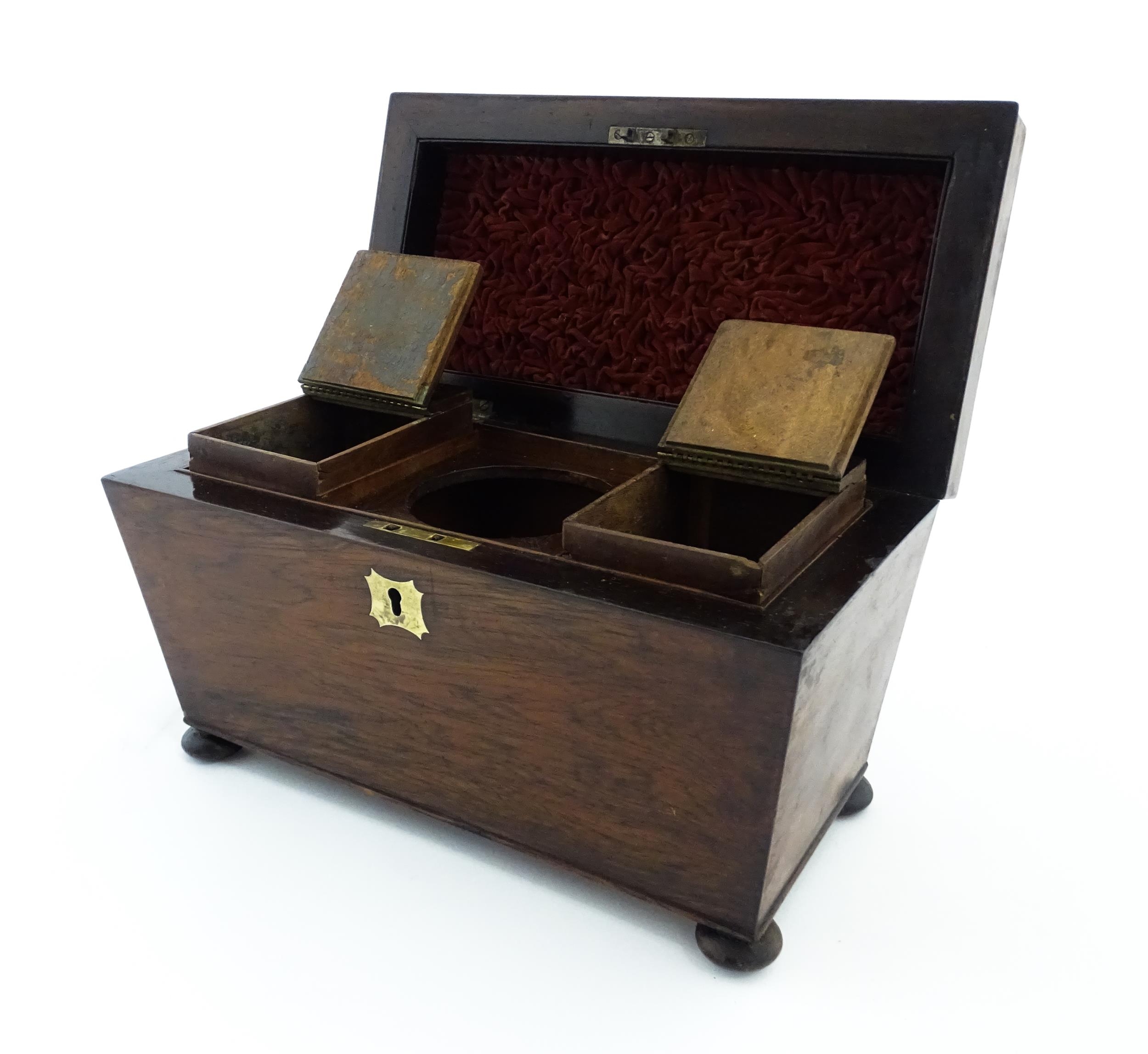 A 19thC rosewood tea caddy of sarcophagus form with four squat bun feet. The interior with two - Image 12 of 15