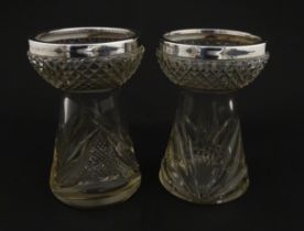 A pair of cut glass vases with silver rims in the style of hyacinth vases, hallmarked Birmingham