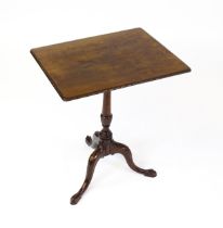 A late 18thC / early 19thC mahogany occasional table with a rectangular top and carved edge above
