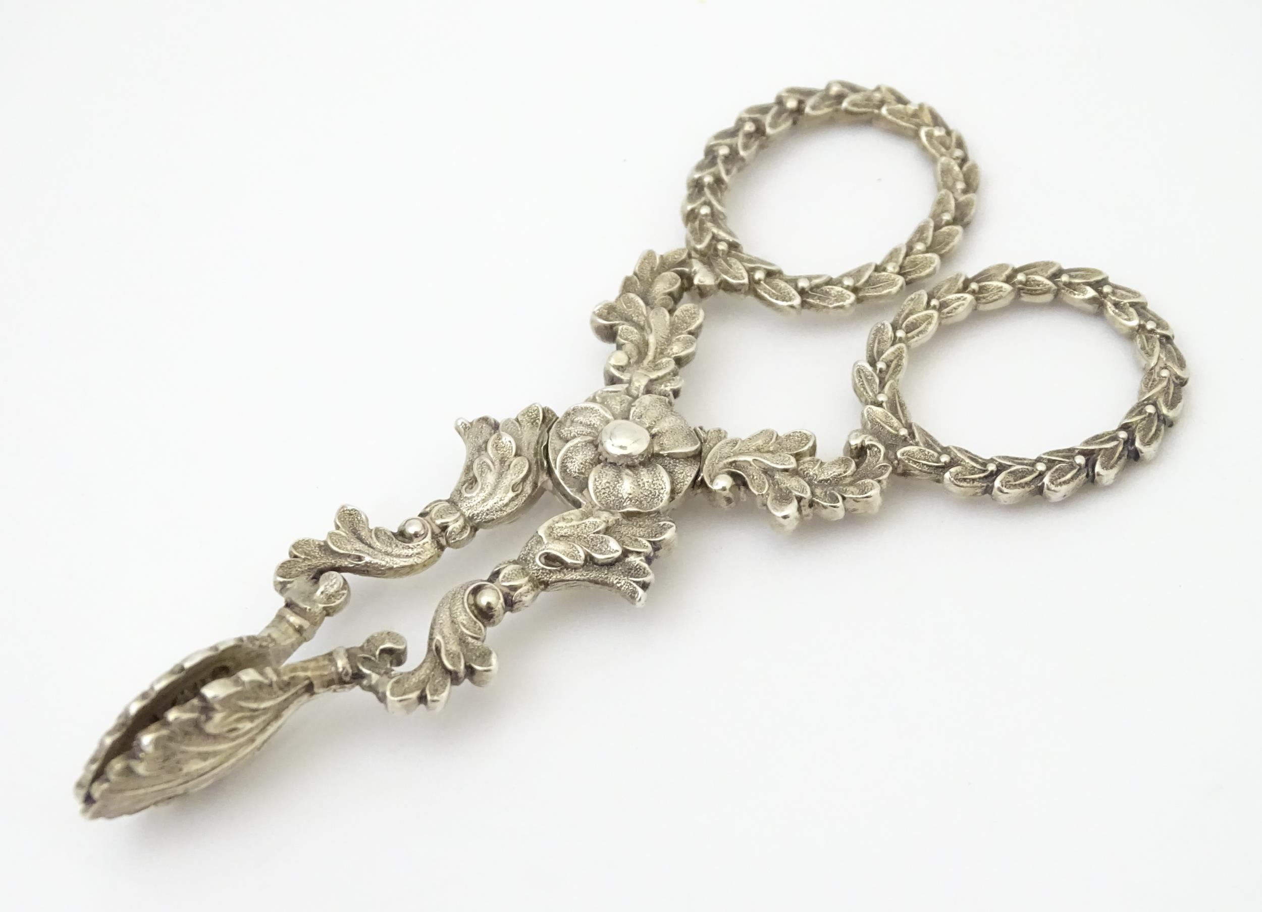 William IV silver sugar nips with foliate detail and laurel chaplet formed handles, hallmarked