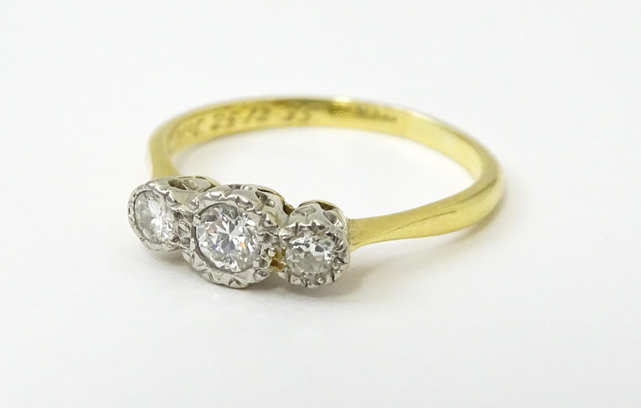 An 18ct gold ring with three platinum set diamonds. Ring size approx. O Please Note - we do not make - Image 11 of 18