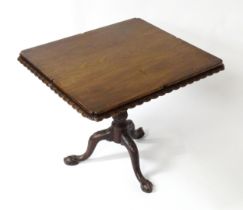A mid / late 18thC mahogany tilt top table with an unusual moulded surround, re-entrant corners