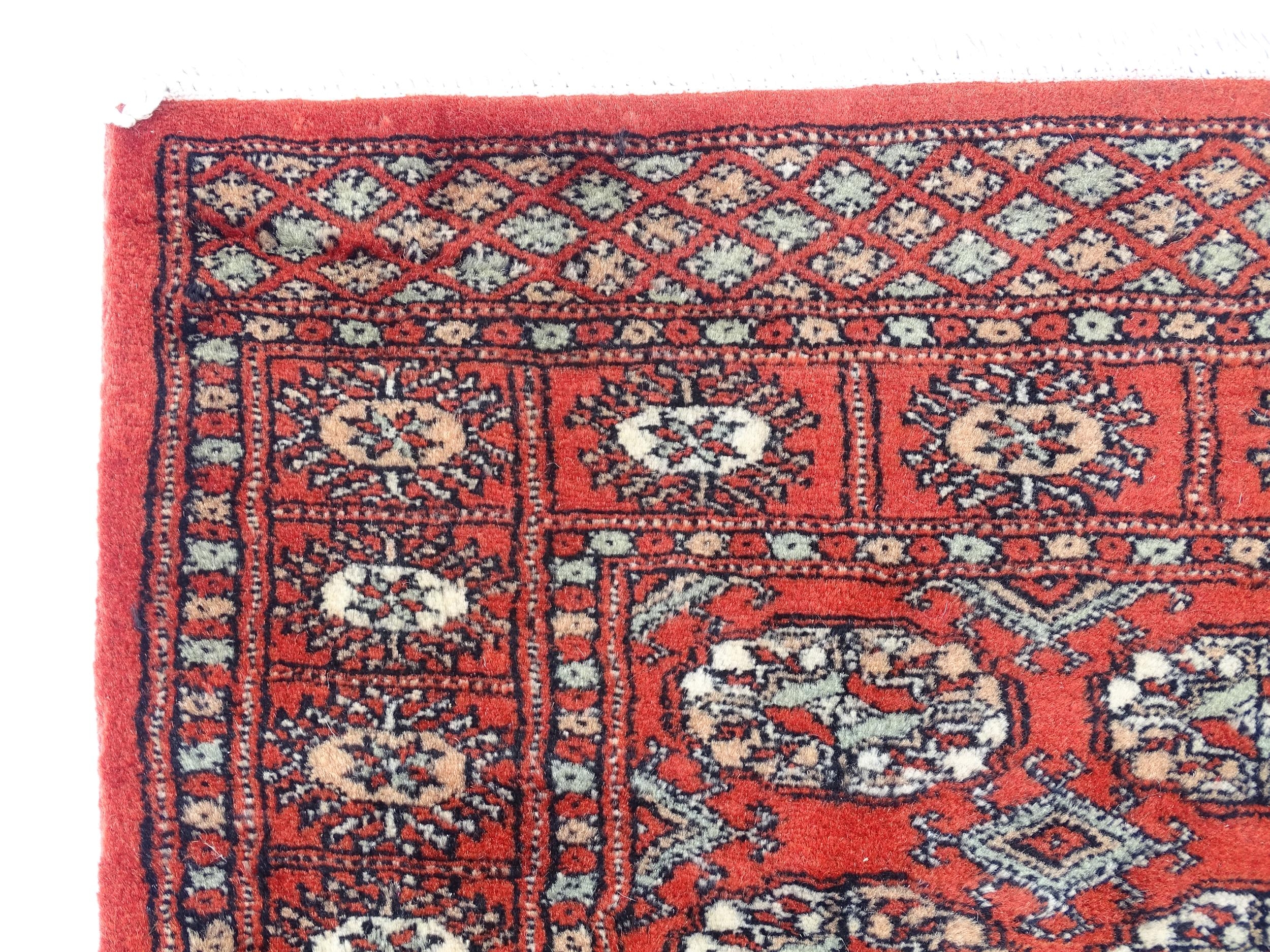 Carpet / Rug : A Pakistan wool red ground rug decorated with repeating geometric motifs with further - Image 3 of 8