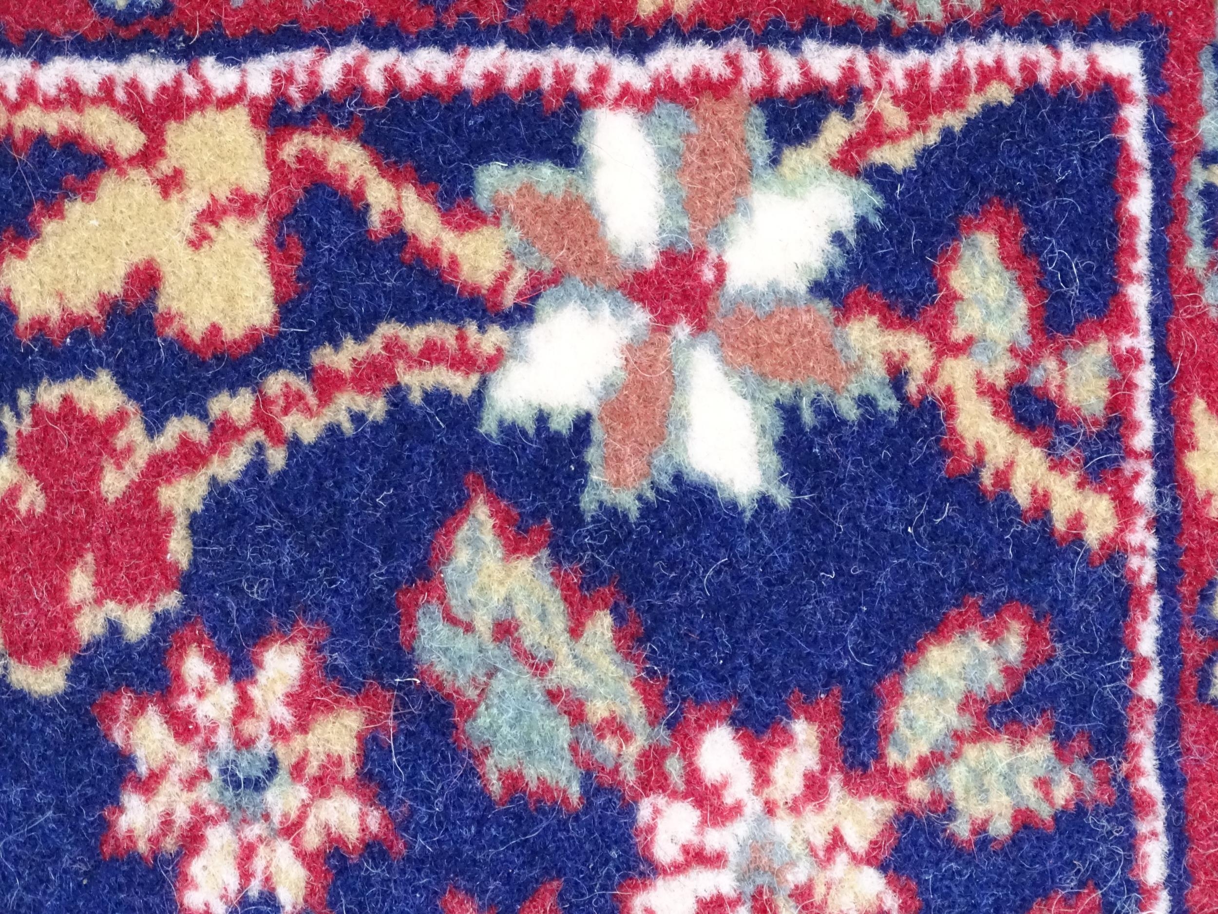 Carpet / Rug : A blue ground wool rug decorated with floral and foliate detail, further repeated - Image 8 of 9