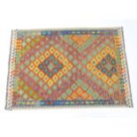 Carpet / Rug : A Turkish Anatolian kilim rug with repeated geometric motifs. Approx. 84" x 59"