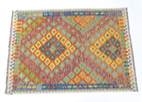 Carpet / Rug : A Turkish Anatolian kilim rug with repeated geometric motifs. Approx. 84" x 59"