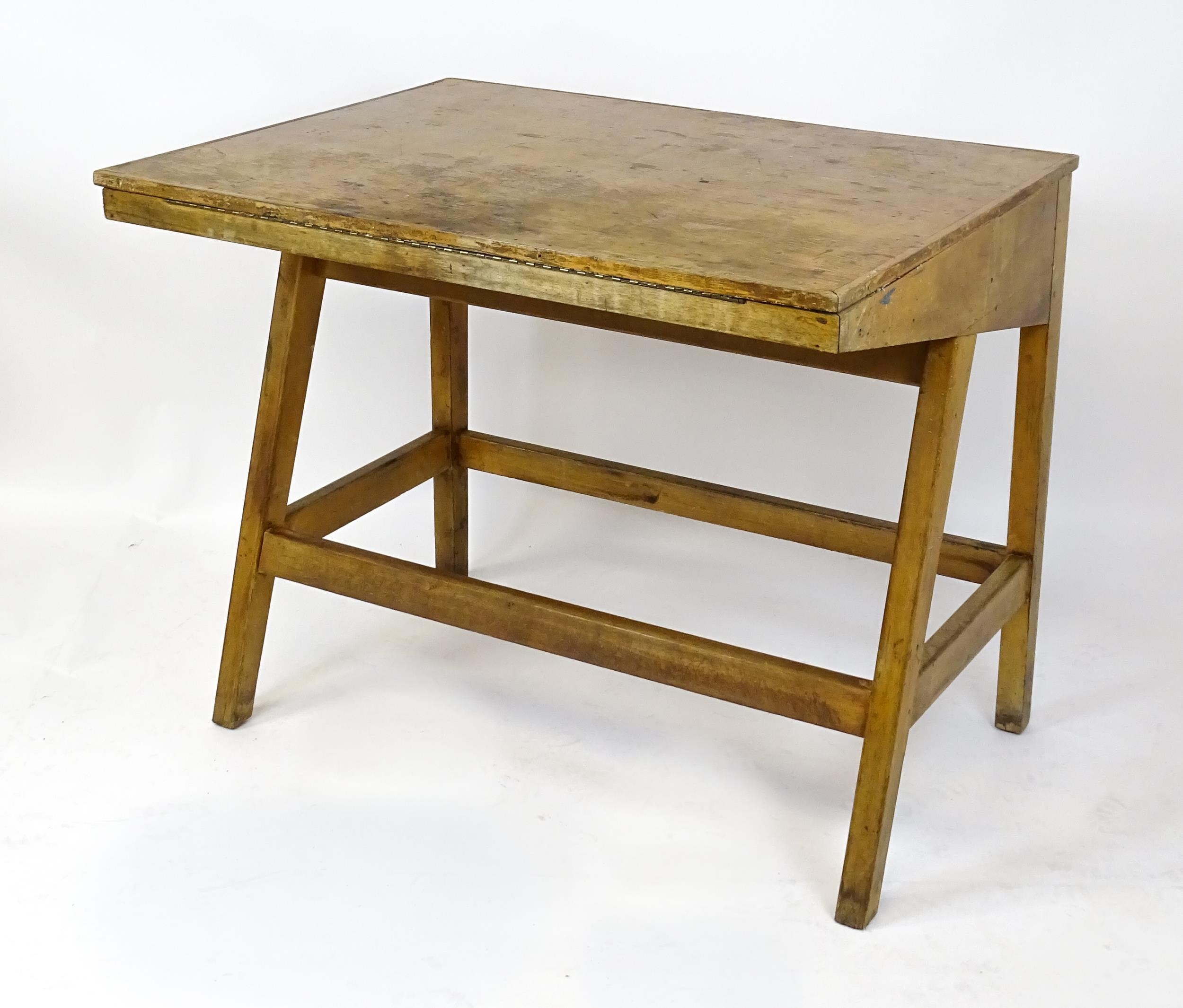 A mid / late 20thC artists desk with a hinged, adjustable top raised on tapering legs united by a - Image 11 of 11