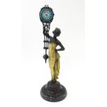 A Continental Art Nouveau style mystery clock (swing clock), with figural detail. Approx. 11 1/2"