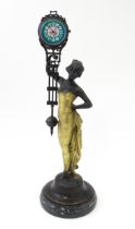 A Continental Art Nouveau style mystery clock (swing clock), with figural detail. Approx. 11 1/2"