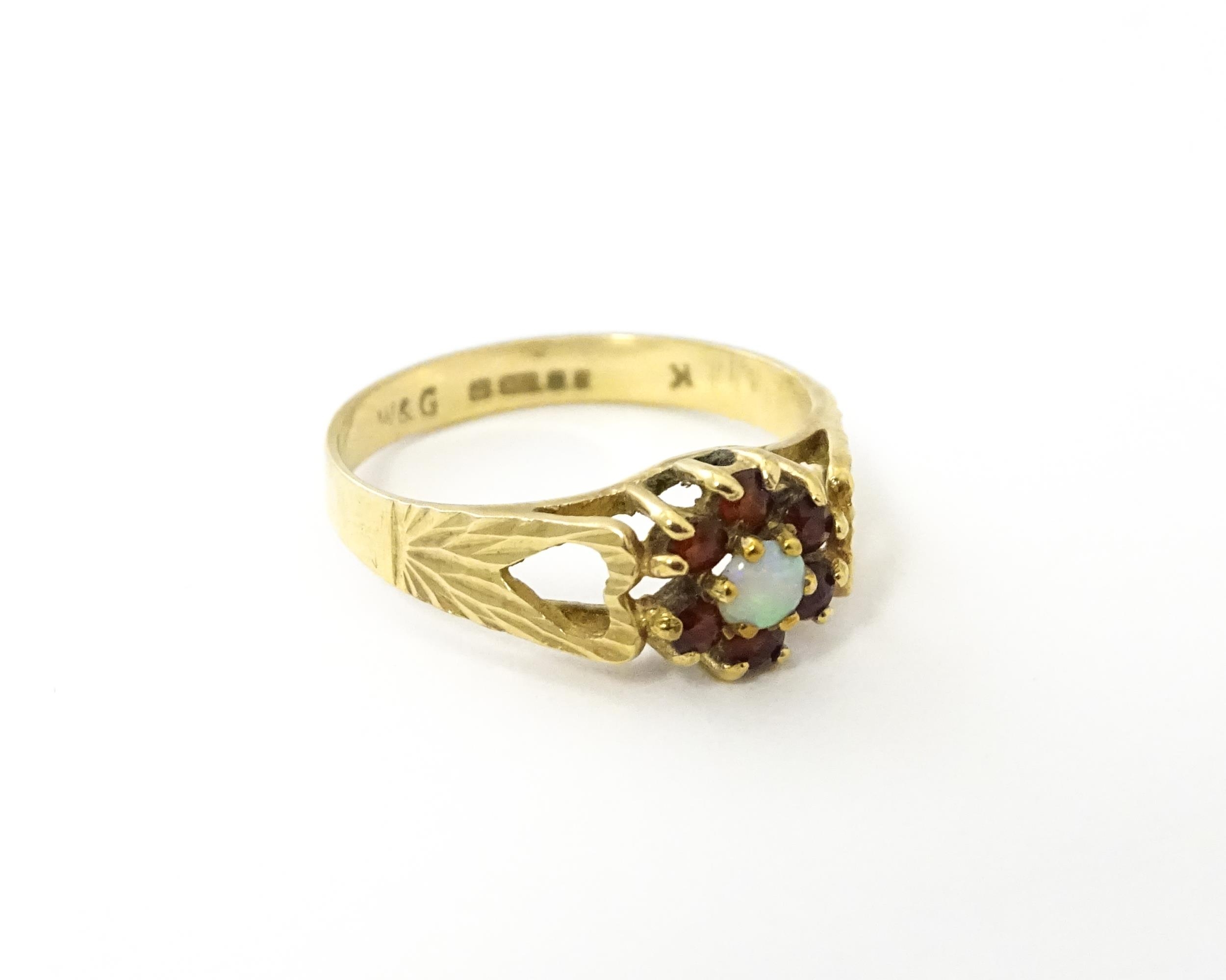 A 9ct gold ring set with central opal bordered by 6 garnets. Ring size approx. L Please Note - we do - Image 4 of 8