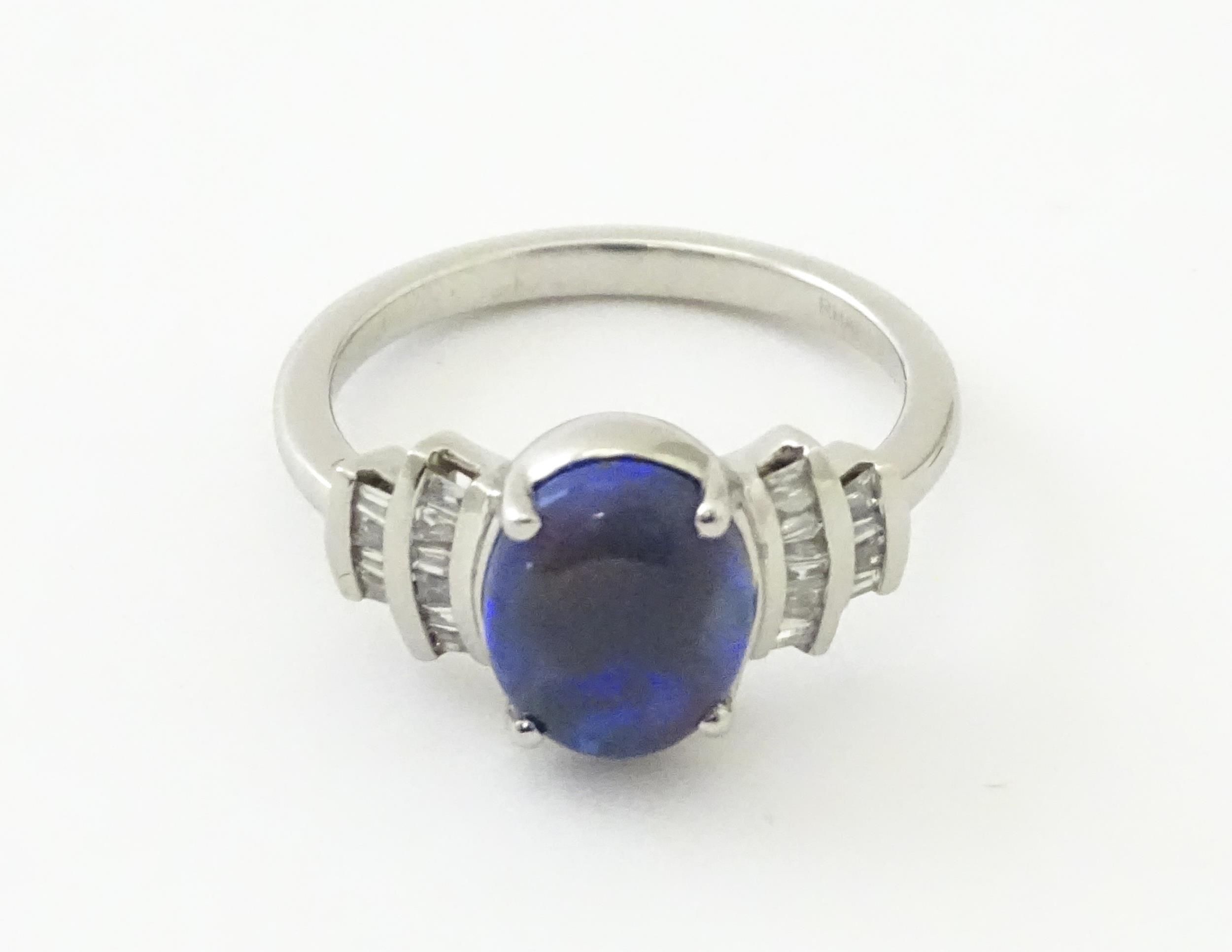 A platinum ring set with central black opal cabochon flanked by diamonds in an Art deco style - Image 2 of 9