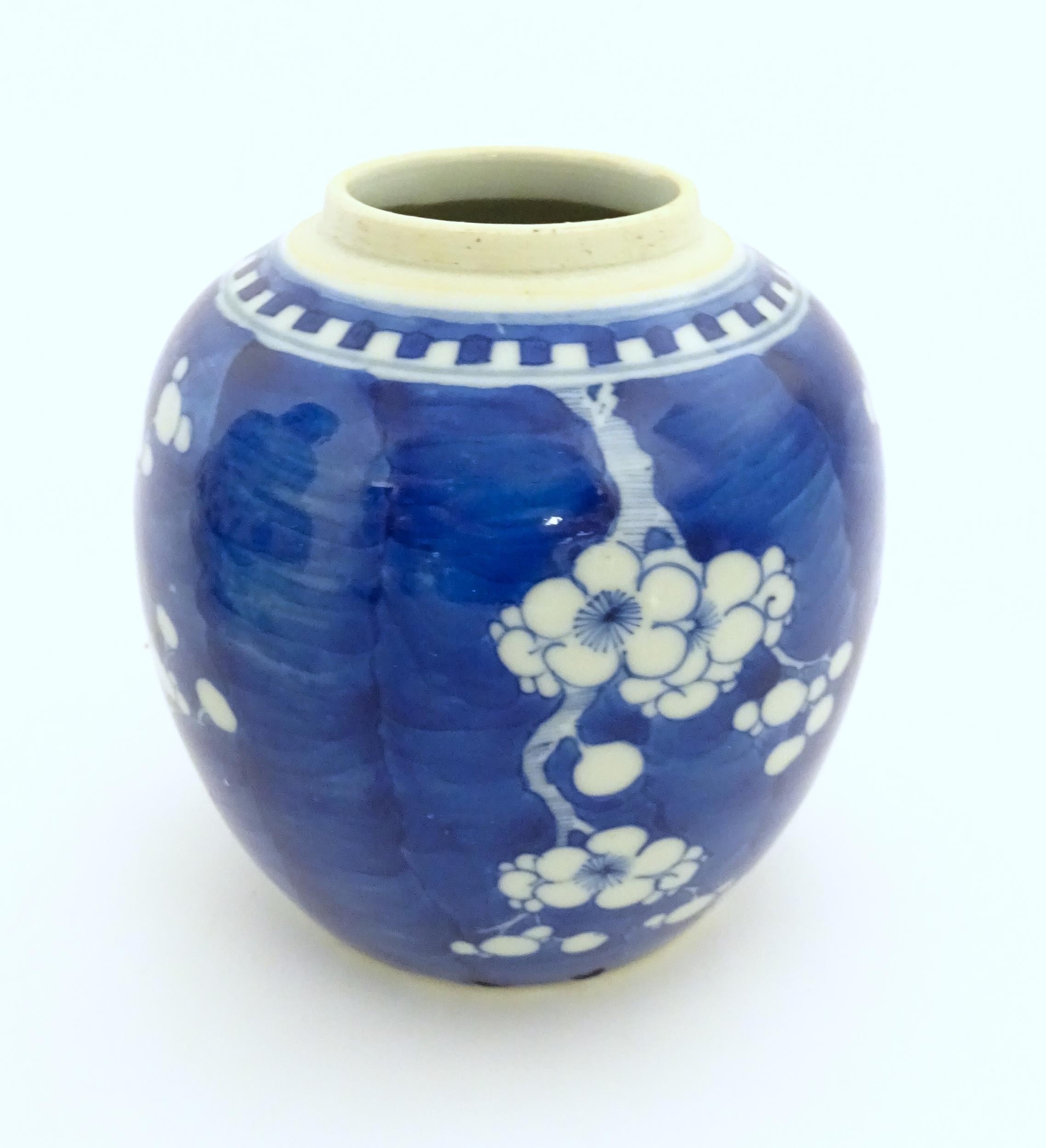 A Chinese blue and white jar decorated with prunus blossom. Character marks under. Approx. 5" high - Image 5 of 7