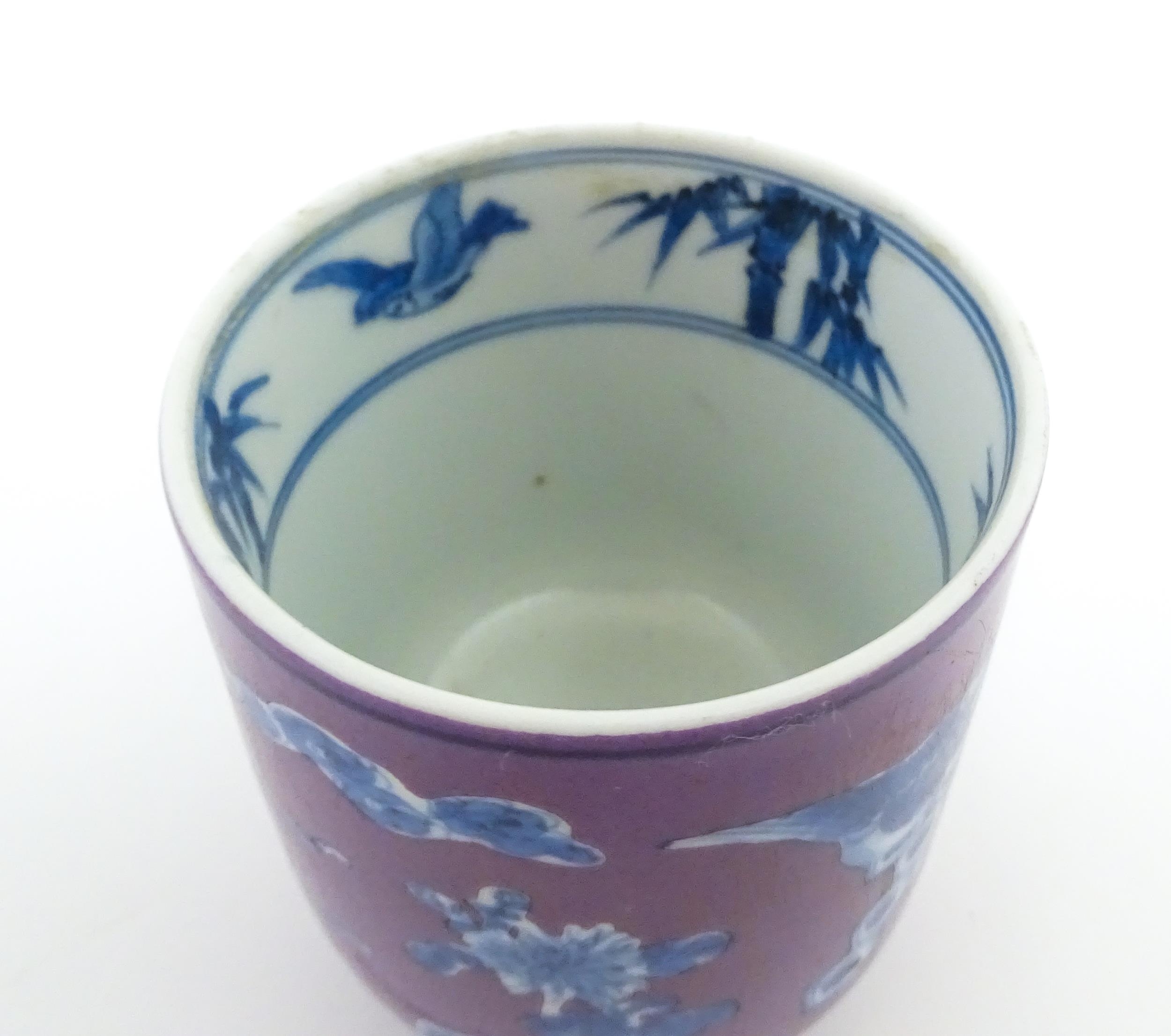 A Chinese cup with a purple ground decorated with birds, foliage and stylised clouds. Character - Image 7 of 8