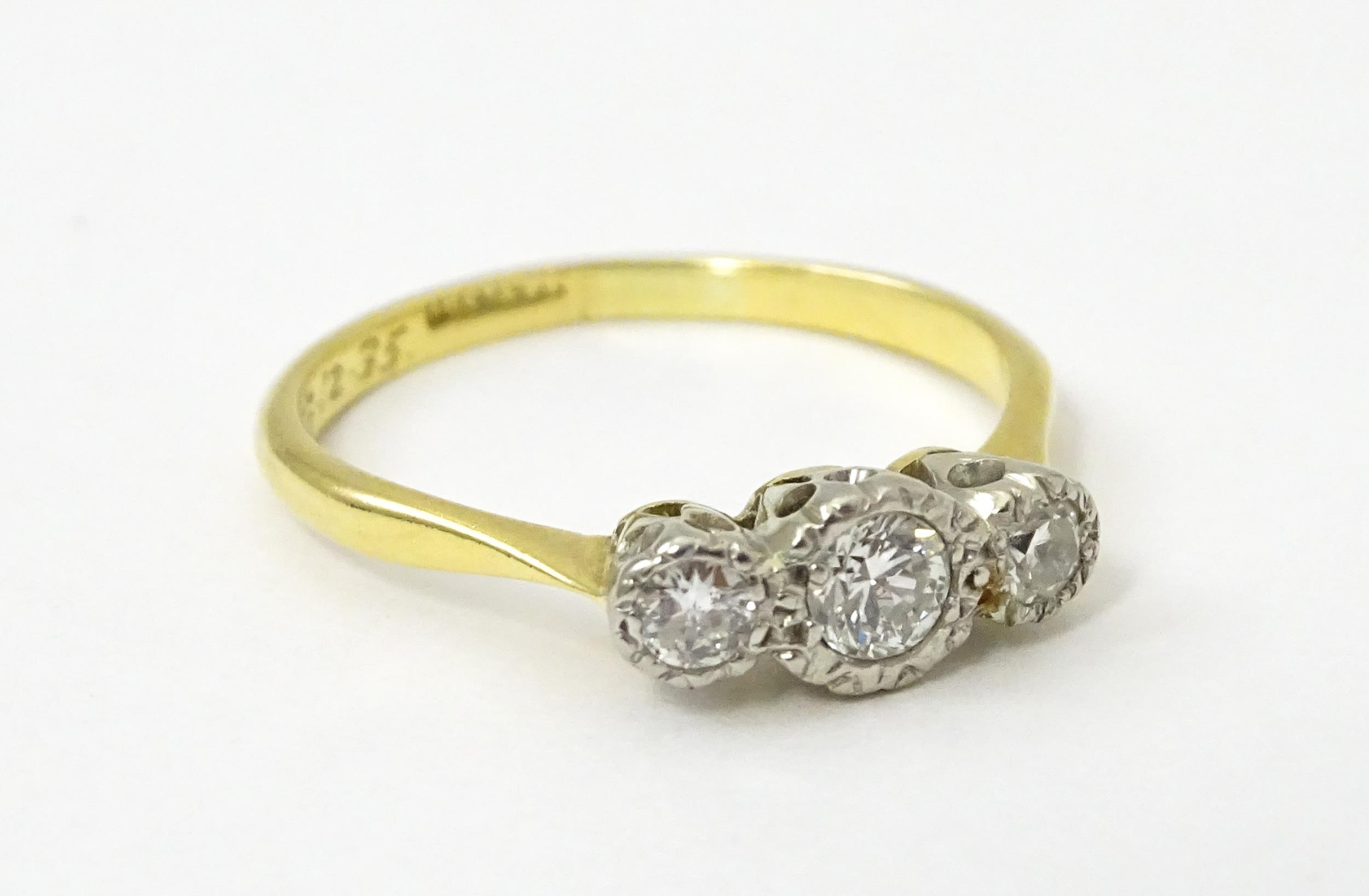 An 18ct gold ring with three platinum set diamonds. Ring size approx. O Please Note - we do not make - Image 9 of 18