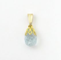 A gilt metal pendant set with facet cut aquamarine coloured drop. Approx. 1/2" long Please Note - we