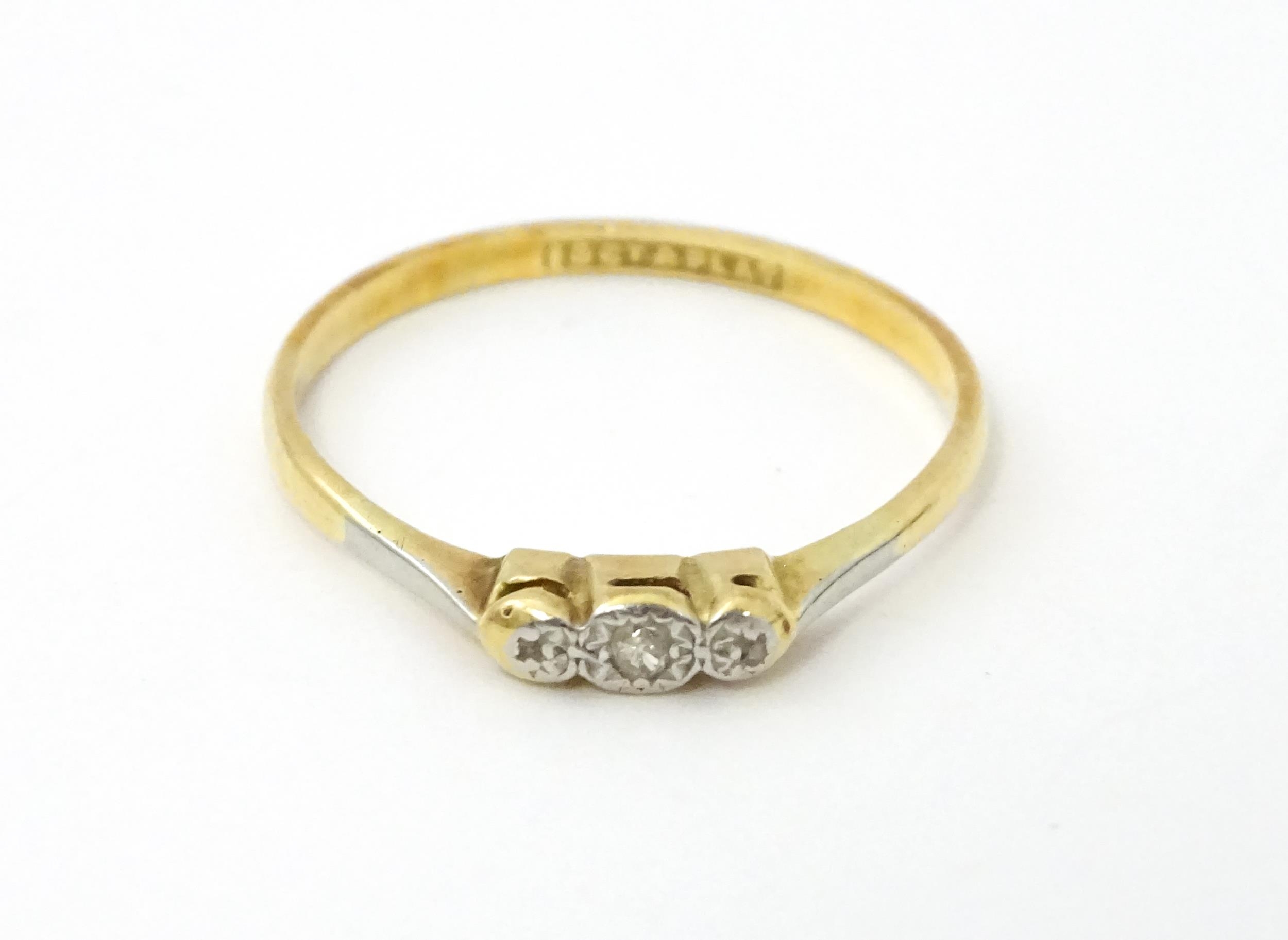 A 18ct gold and platinum ring with illusion set diamond. Ring size approx. X 1/2 Please Note - we do