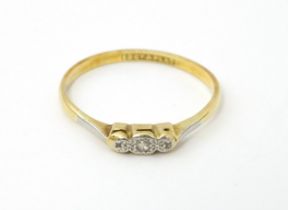 A 18ct gold and platinum ring with illusion set diamond. Ring size approx. X 1/2 Please Note - we do