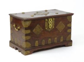 A 19thC marriage chest / dowry chest with brass mounts and brackets decorating the exterior