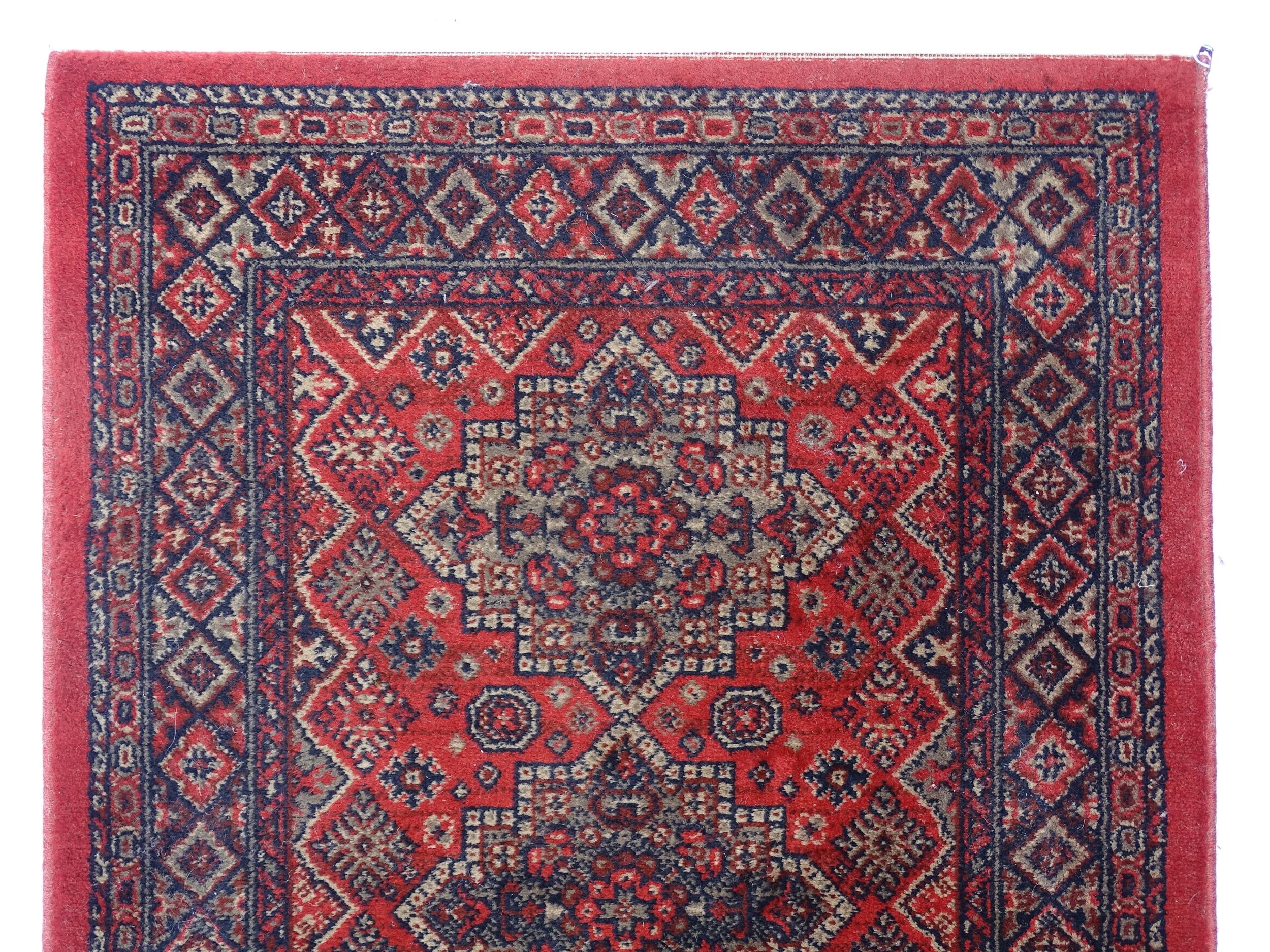 Carpet / Rug : A red ground runner with repeating motifs to centre, bordered by geometric banding. - Image 4 of 8