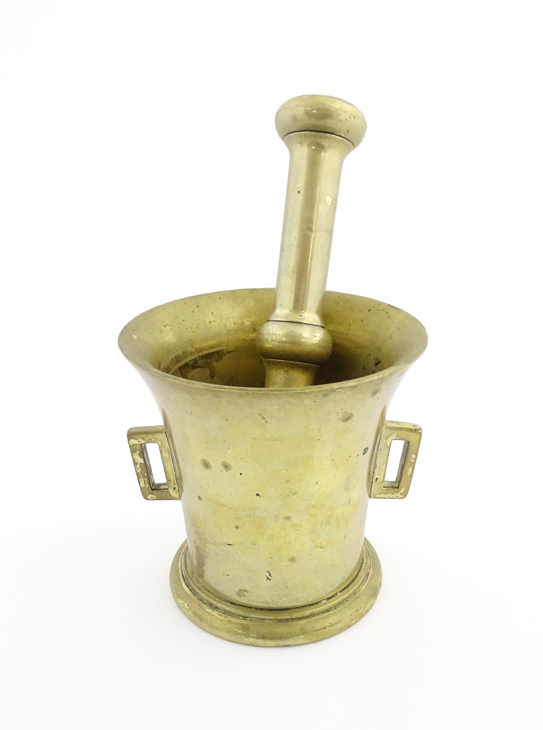 A 19thC brass pestle and mortar, the mortar of tapering form with twin rectangular handles. Mortar - Image 2 of 14