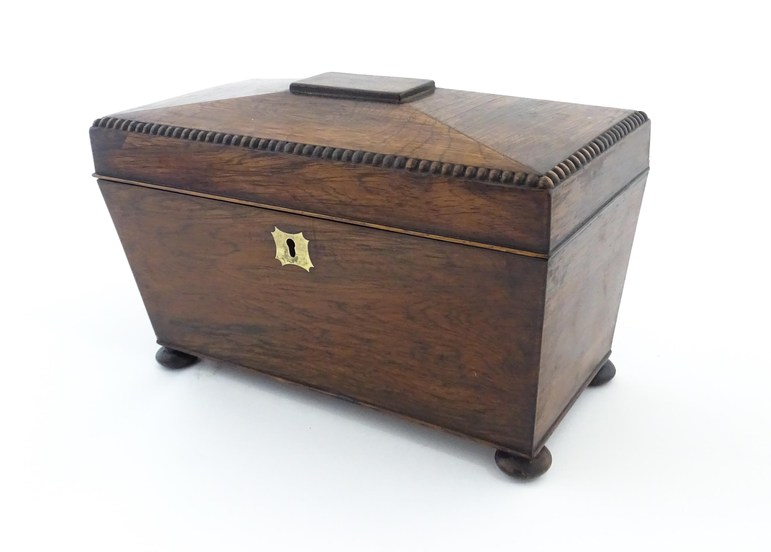 A 19thC rosewood tea caddy of sarcophagus form with four squat bun feet. The interior with two - Image 4 of 15