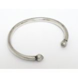 A white metal torque bangle / bracelet Please Note - we do not make reference to the condition of