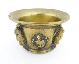 A small late 17th / early 18thC bronze mortar with mask / cherub head detail. Approx. 2 3/4" high