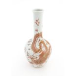 A Chinese bottle vase decorated with a dragon, flaming pearl, stylised clouds and waves. Character